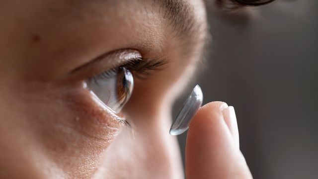 Person inserting a contact lens. 