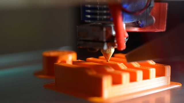 The tip of a 3D printer. 