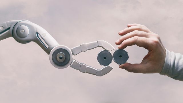 An image of a robot meeting a human hand. 