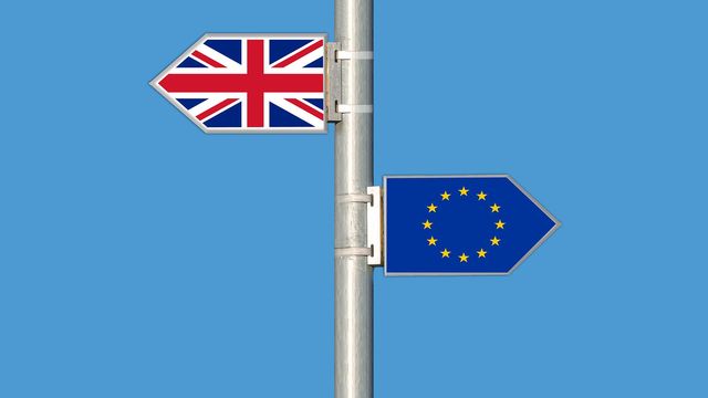 Signpost with arrow of the Union Jack pointing left and EU flag pointing right. 